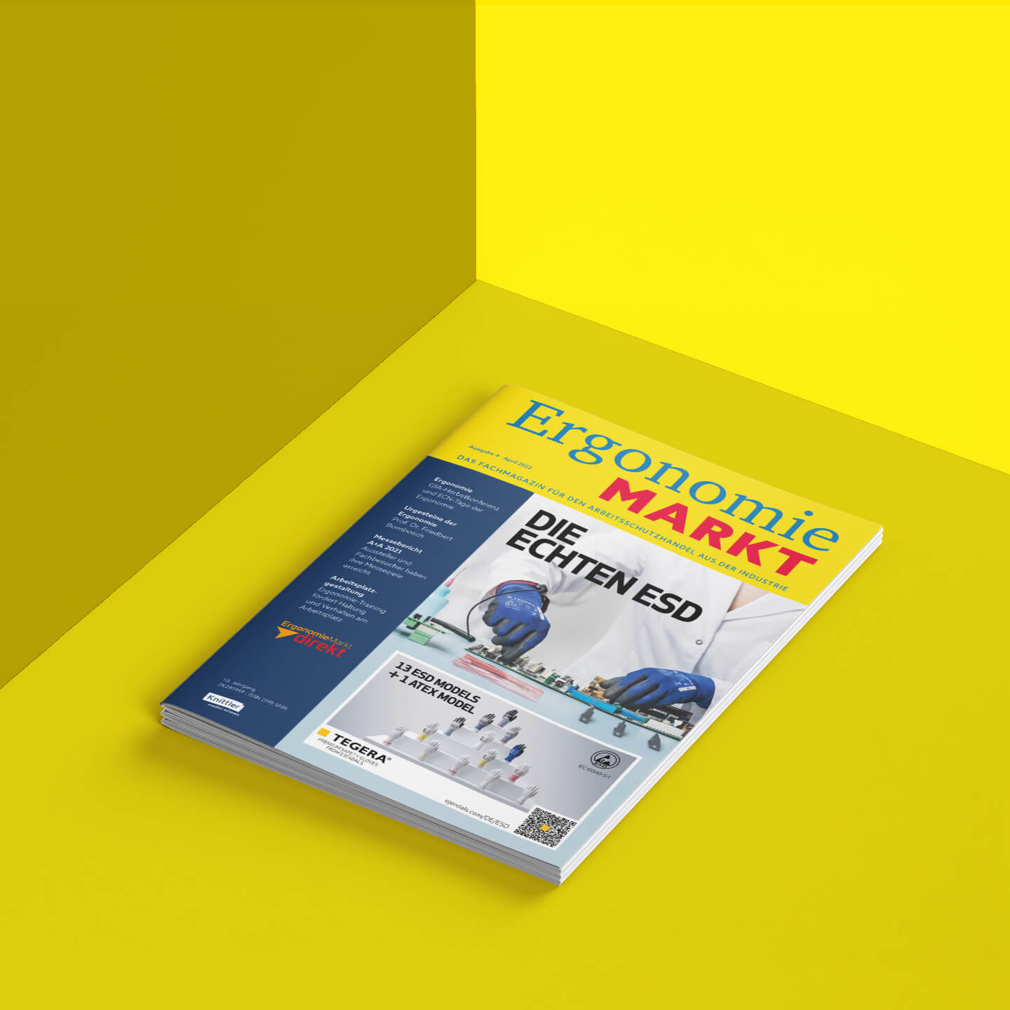 Ein ErgnomieMarkt-Heft vor einem einfarbig gelben Hintergrund